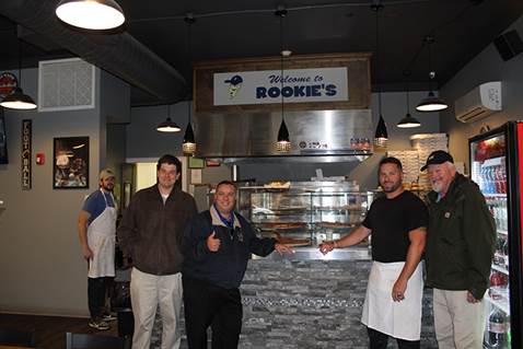 Brabenec [center left] poses with owners of Rookies on Main Street in Florida.